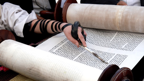 Reading from an open Torah scroll